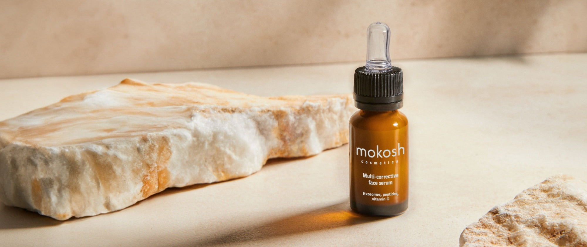 Mokosh skincare product with a stone on a beige background